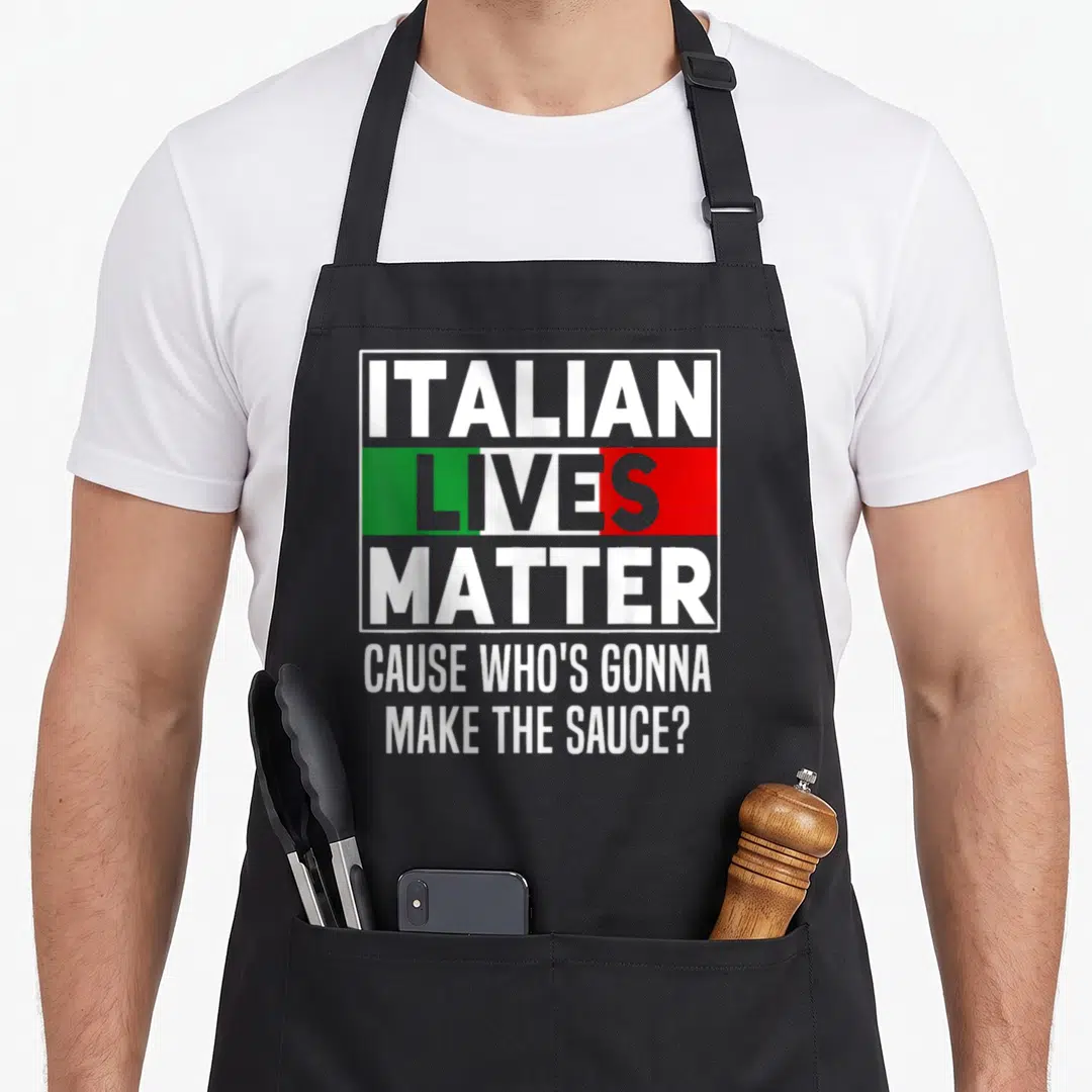 Live italian apron - Stacked text Italian Lives Matter Cause Who's Gonna Make The Sauce with flag colors — shown on a black cotton canvas apron against a white background