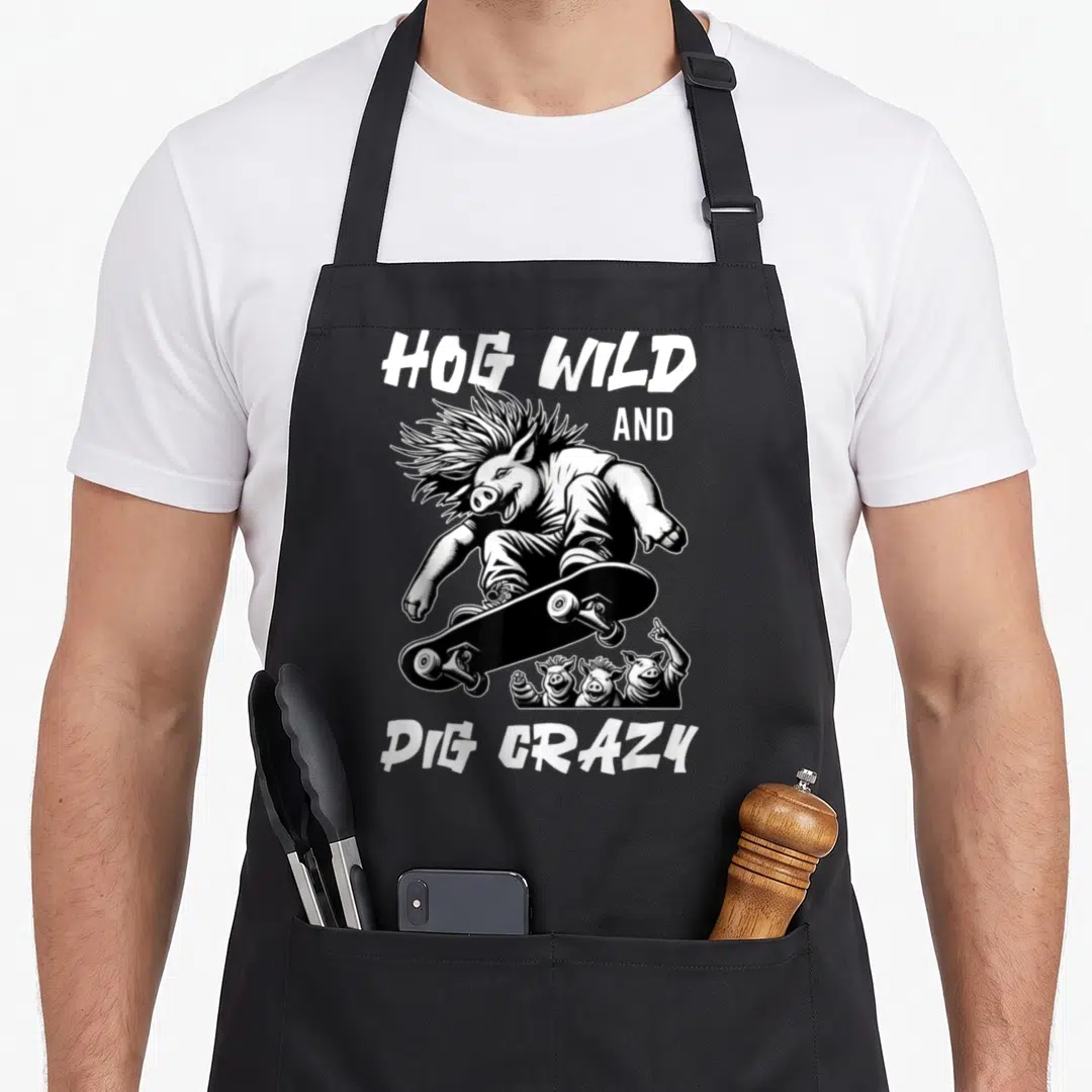 Hog farm apron - Black and white line art of a punk pig on a skateboard with three smaller pigs and text HOG WILD — shown on a black cotton canvas apron against a white background