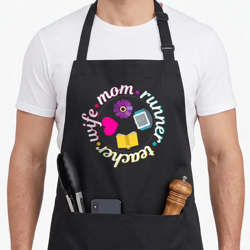 Runner best teacher apron - Circular text wife mom runner teacher surrounding flower heart book and tracker icons — shown on a black cotton canvas apron against a white background