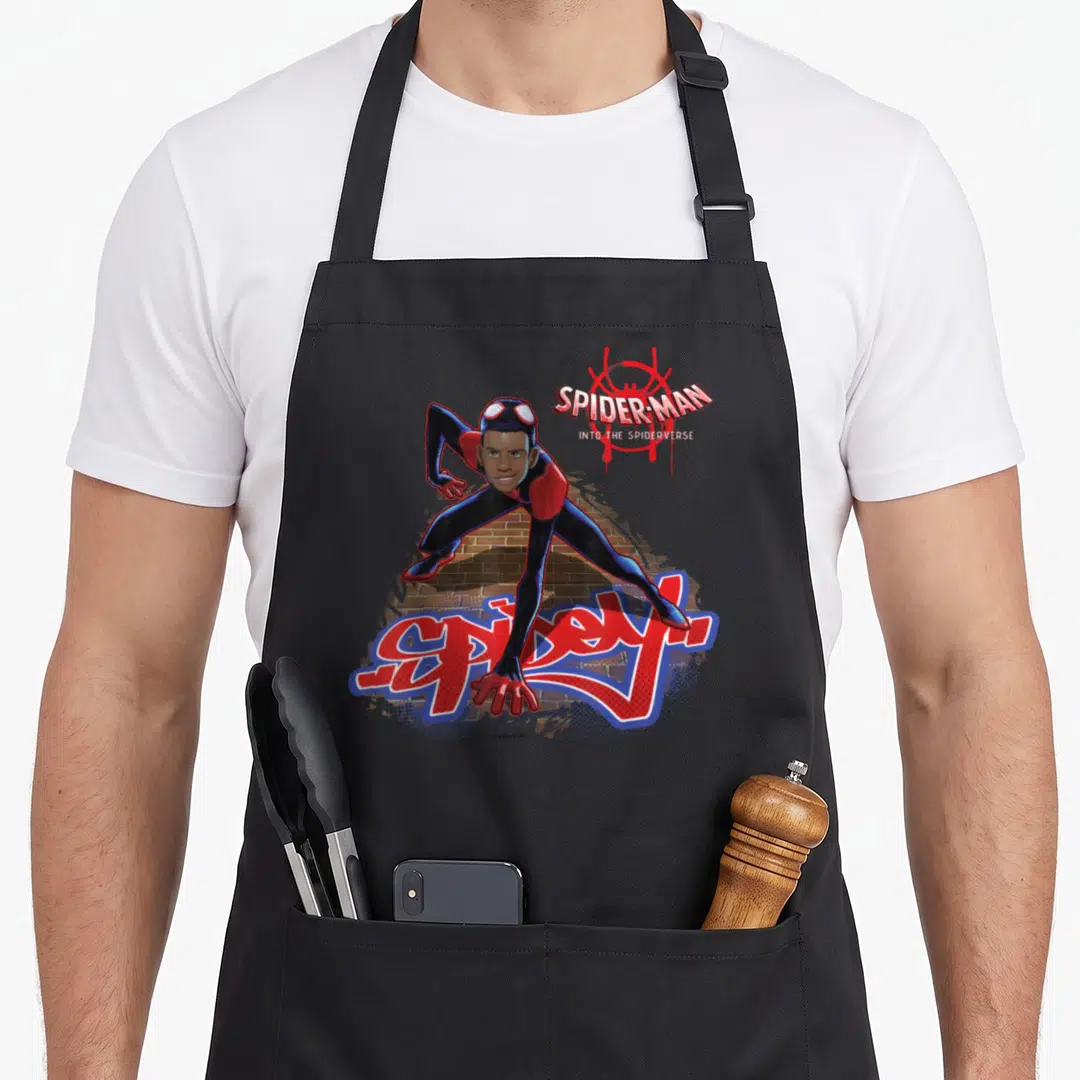 Spiderverse animal apron - Miles Morales crouching over Spidey graffiti text on brick background — shown on a black cotton canvas apron against a white background