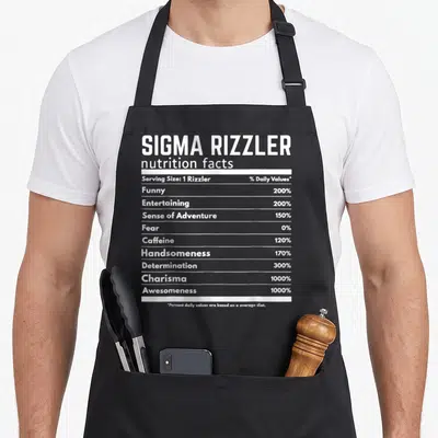 Sigma meme apron - White nutrition facts label text listing 1000% charisma and awesomeness on black background — shown on a black cotton canvas apron against a white background