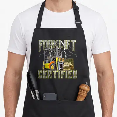 Operator forklift apron - Yellow forklift lifting cash stacks with rhinestone FORKLIFT CERTIFIED text and lightning — shown on a black cotton canvas apron against a white background