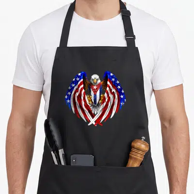 Cuba eagle american flag apron - Realistic eagle with wings patterned in blue red and white flag stripes and stars — shown on a black cotton canvas apron against a white background