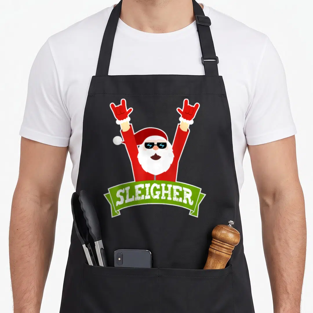 Sleigher heavy apron - Santa in red suit with sunglasses holding rock signs above green SLEIGHER banner — shown on a black cotton canvas apron against a white background