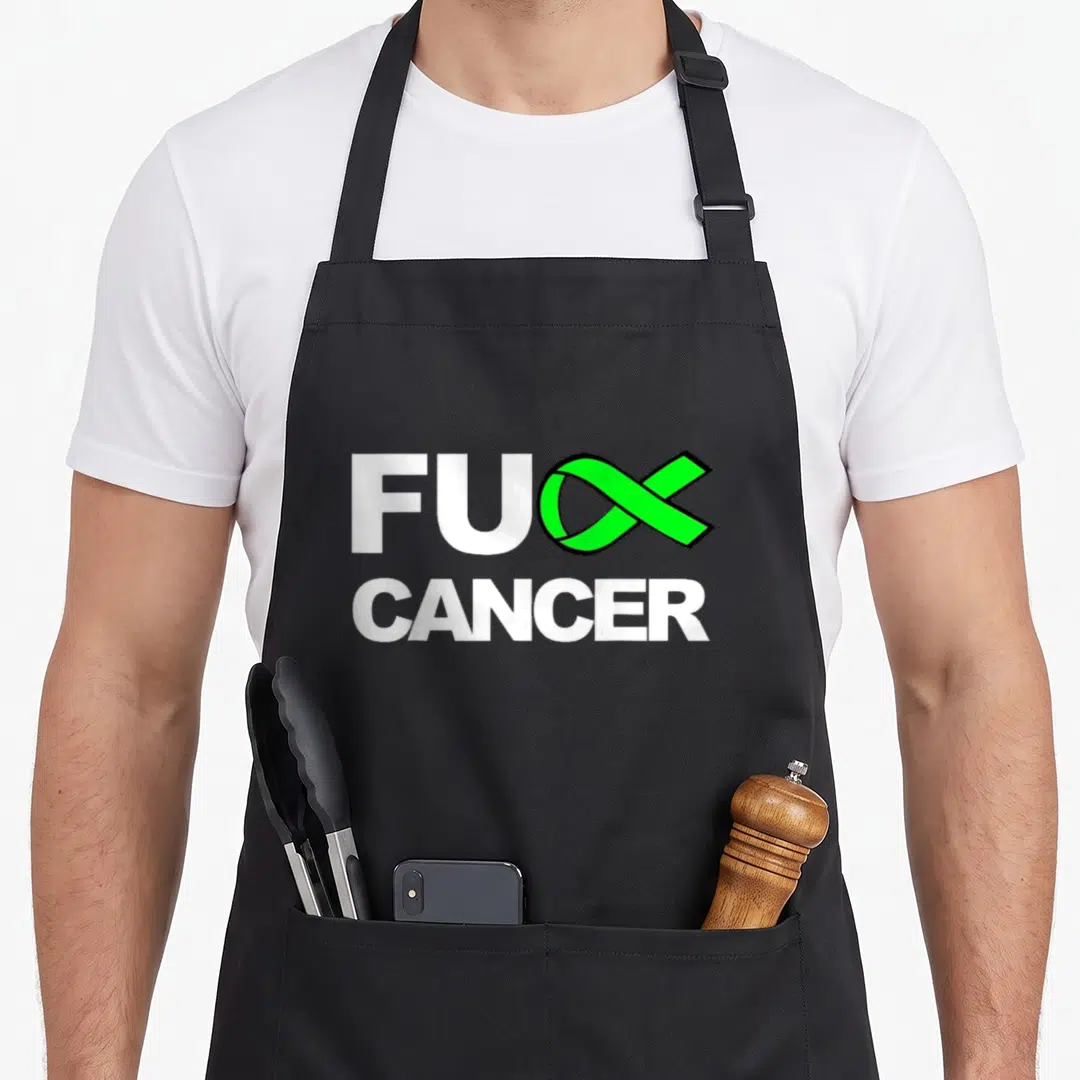 Cancer lymphoma awareness apron - FUC CANCER text with green ribbon replacing the letter K — shown on a black cotton canvas apron against a white background