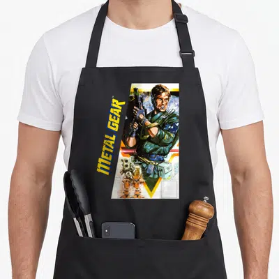 Metal tactical apron - Vertical METAL GEAR text beside illustrated man holding gun with robot and box — shown on a black cotton canvas apron against a white background
