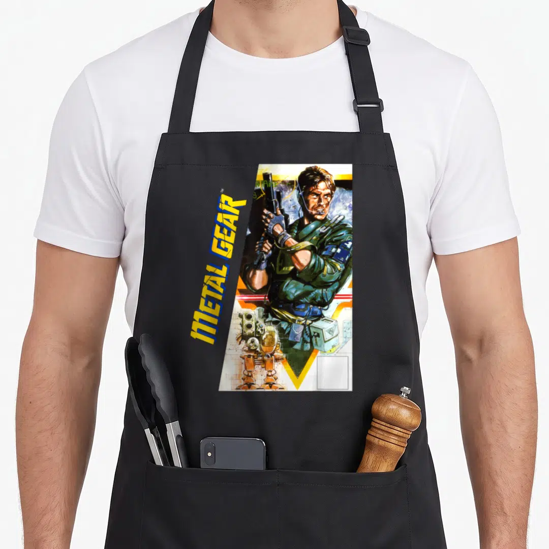 Metal tactical apron - Vertical METAL GEAR text beside illustrated man holding gun with robot and box — shown on a black cotton canvas apron against a white background