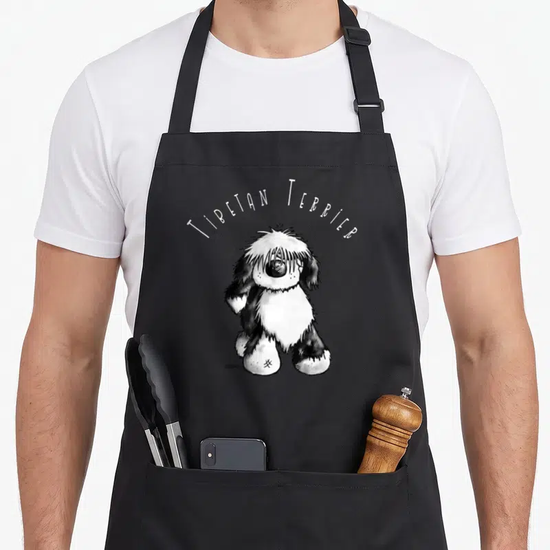 Lovely tibetan apron - Cartoon Tibetan Terrier with arched text in white and black — shown on a black cotton canvas apron against a white background