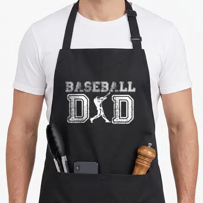 Baseball grill daddy apron - White distressed baseball dad text with batter silhouette between the Ds — shown on a black cotton canvas apron against a white background