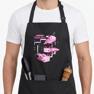 Pond girl axolotl apron - Three pink pixelated axolotls with MINECRAFT text and white bubbles — shown on a black cotton canvas apron against a white background