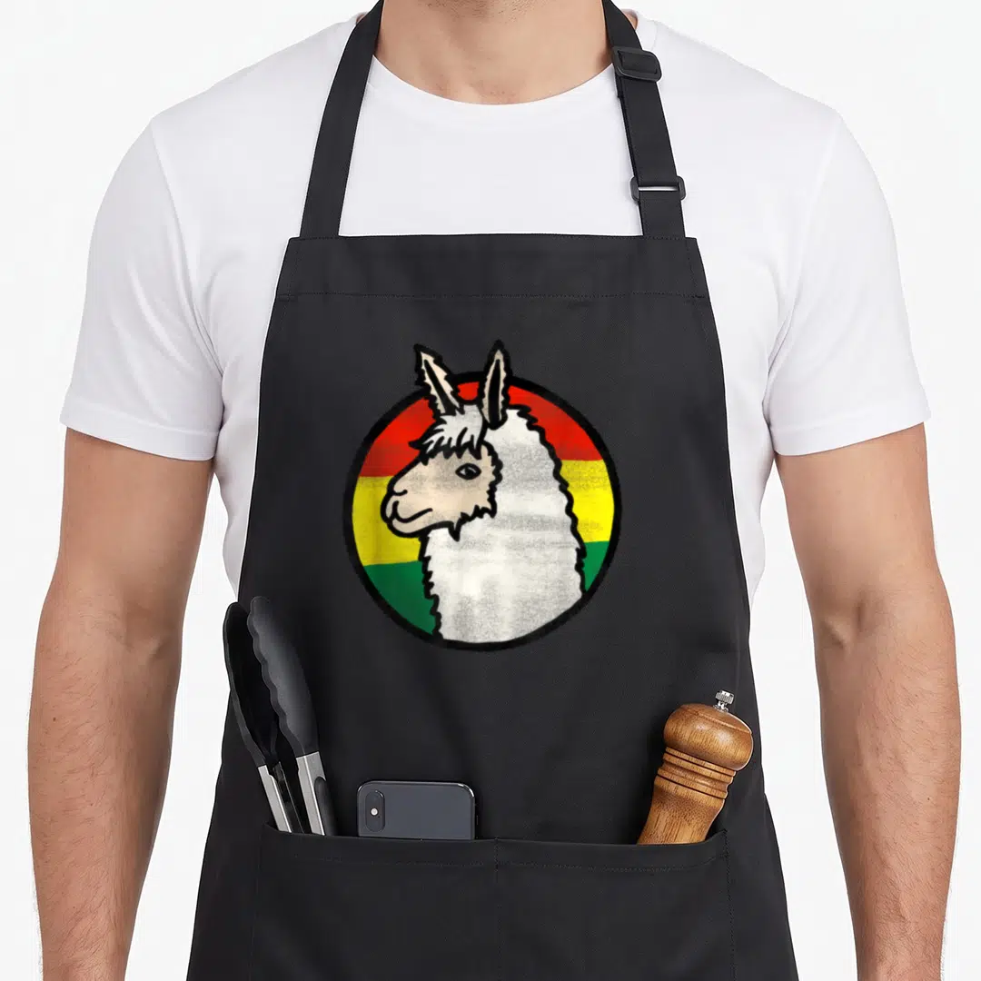 Bolivia travel aprons - Cartoon llama head centered on red yellow green white circular stripes — shown on a black cotton canvas apron against a white background