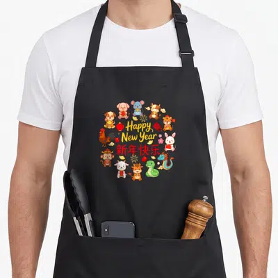 Lunar chinese zodiac aprons - Happy New Year text and Chinese characters surrounded by twelve colorful cartoon zodiac — shown on a black cotton canvas apron against a white background