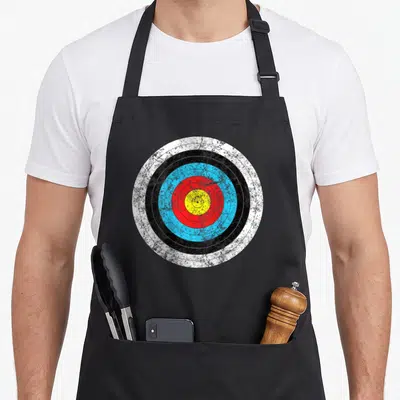 Archery hunter apron - Distressed archery target with white, black, blue, red, and yellow concentric rings — shown on a black cotton canvas apron against a white background