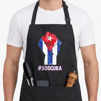Cuban lucha libre apron - Raised fist filled with Cuban flag colors and text #SOSCUBA below — shown on a black cotton canvas apron against a white background