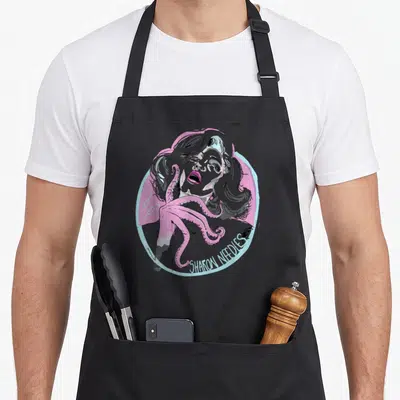 Sharon queen apron - Pink tentacle wrapping woman inside blue circle with Sharon Needs text — shown on a black cotton canvas apron against a white background