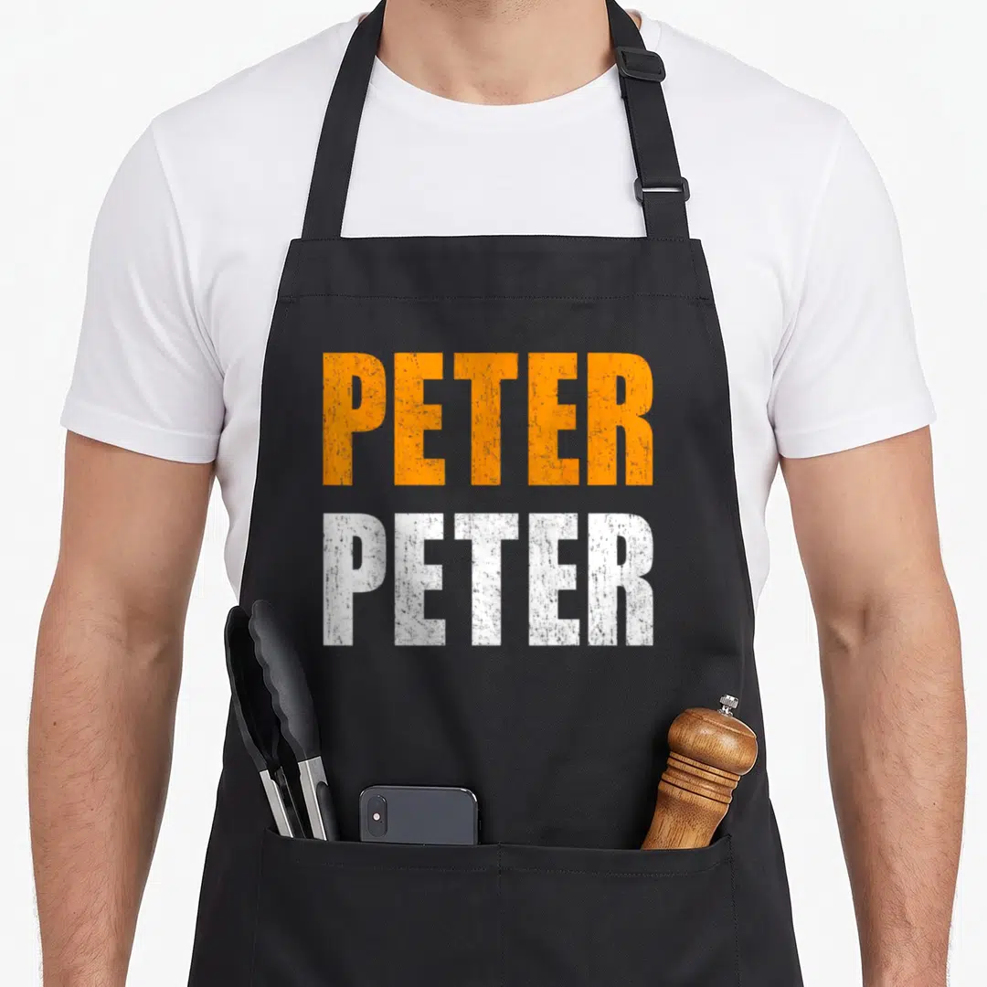 Costume peter pumpkin halloween apron - Stacked orange and white distressed PETER text on black bib apron — shown on a black cotton canvas apron against a white background
