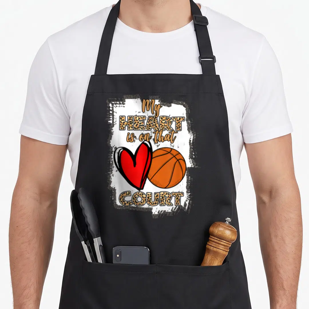 Player leopard apron - Stacked text My HEART is on that COURT with red heart and orange basketball over white brush — shown on a black cotton canvas apron against a white background