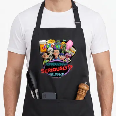 Jeff wi aprons - Jeff Dunham characters, State Fair text, cotton candy, beer, ferris wheel, neon sign — shown on a black cotton canvas apron against a white background