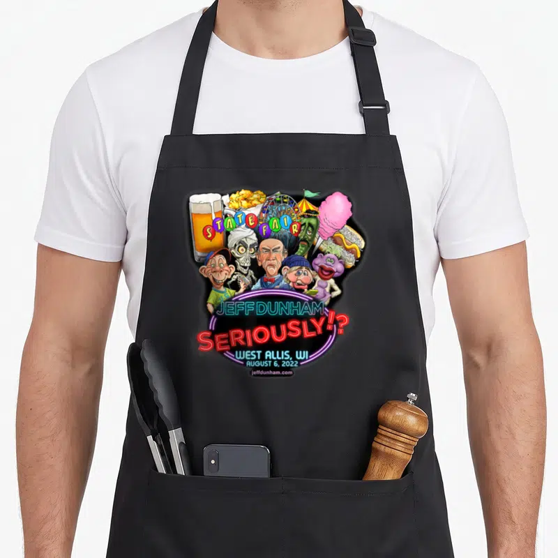 Jeff wi aprons - Jeff Dunham characters, State Fair text, cotton candy, beer, ferris wheel, neon sign — shown on a black cotton canvas apron against a white background