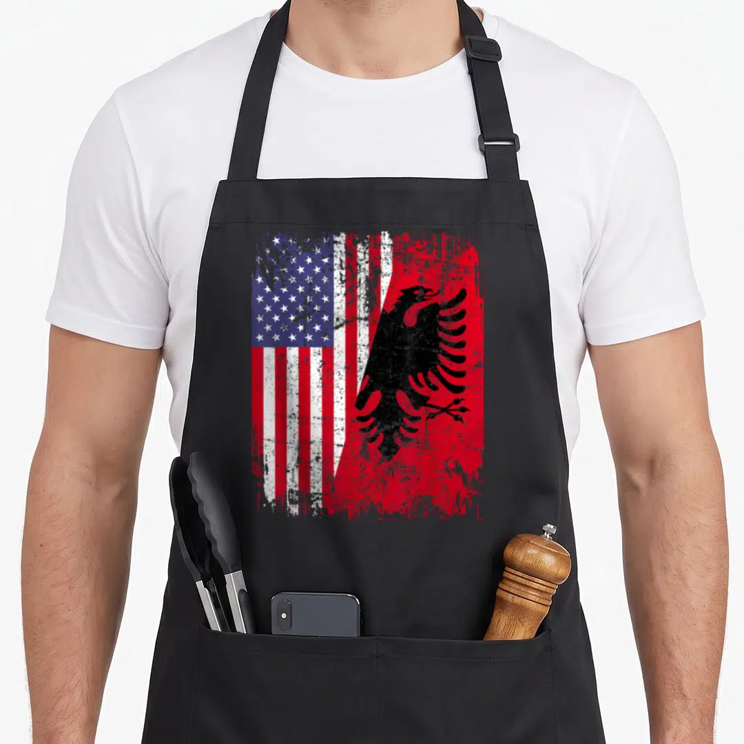 Albanian root american flag apron - Distressed merge of US stars stripes and black eagle on red background — shown on a black cotton canvas apron against a white background