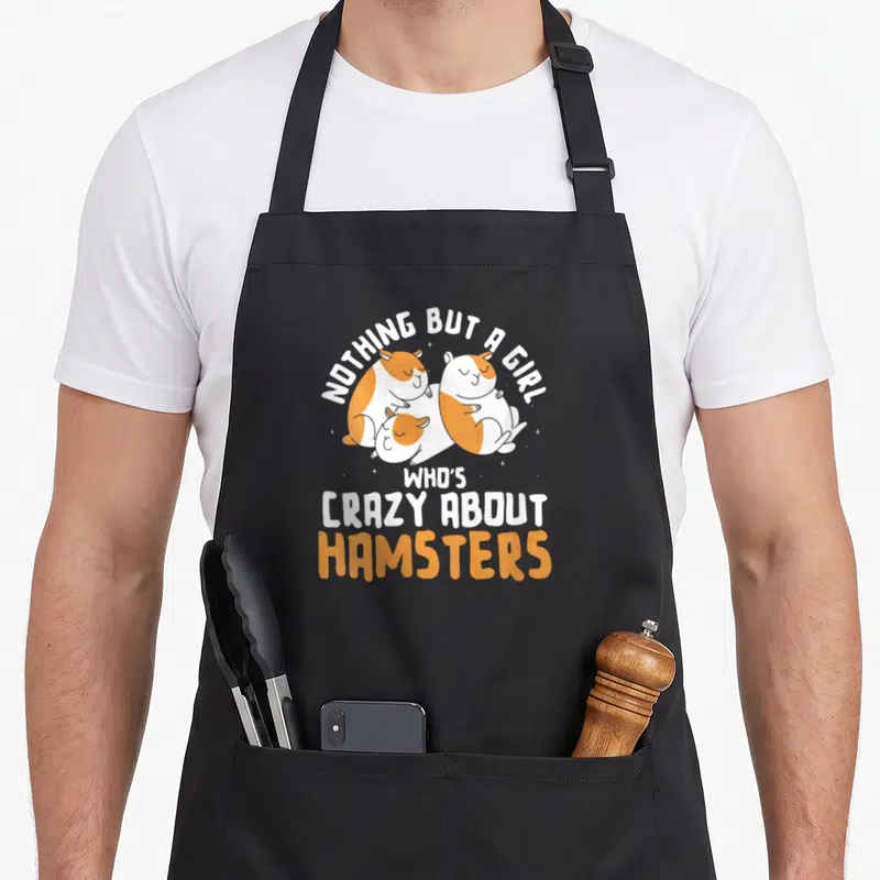 Hamster nothing but apron - Three sleeping white and orange hamsters with stars and text NOTHING BUT A GIRL WHO'S CRAZY — shown on a black cotton canvas apron against a white background