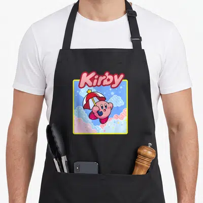 Floating kawaii apron - Kirby text above pink character holding umbrella in blue sky with stars and clouds — shown on a black cotton canvas apron against a white background
