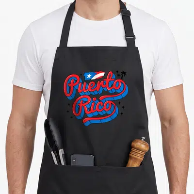 Month hispanic aprons - Retro 3D Puerto Rico text with flag map and palm trees in red blue white — shown on a black cotton canvas apron against a white background