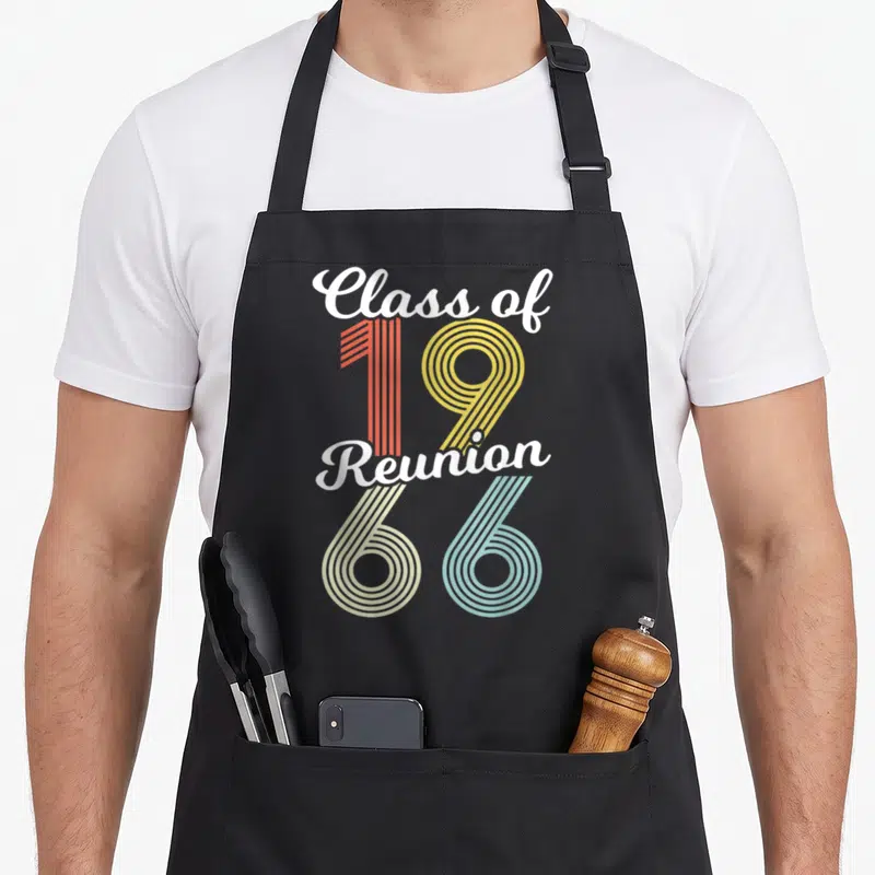 Celebration class reunion apron - Class of 19 Reunion 66 text with red yellow beige and blue parallel line numbers — shown on a black cotton canvas apron against a white background