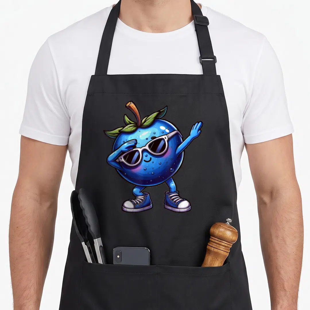 Blue fruit apron - Cartoon blueberry character dabbing with white sunglasses and blue sneakers — shown on a black cotton canvas apron against a white background