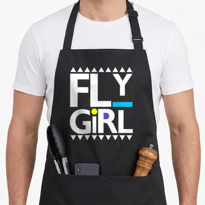 Fly hip aprons - Stacked FLY GiRL text in white with blue bar, yellow dot, and triangle borders — shown on a black cotton canvas apron against a white background