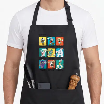 Cuphead colorful aprons - Nine cartoon characters on yellow blue red and white squares with names like Mugman — shown on a black cotton canvas apron against a white background