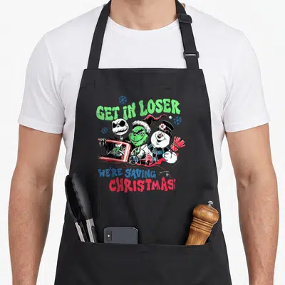 Loser christmas santa apron - Get In Loser We're Saving Christmas text with Grinch Jack Skellington and snowman — shown on a black cotton canvas apron against a white background