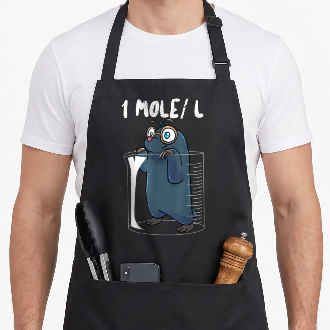 Chemist chemistry apron - Cartoon mole in beaker with 1 MOLE/L text and glasses — shown on a black cotton canvas apron against a white background