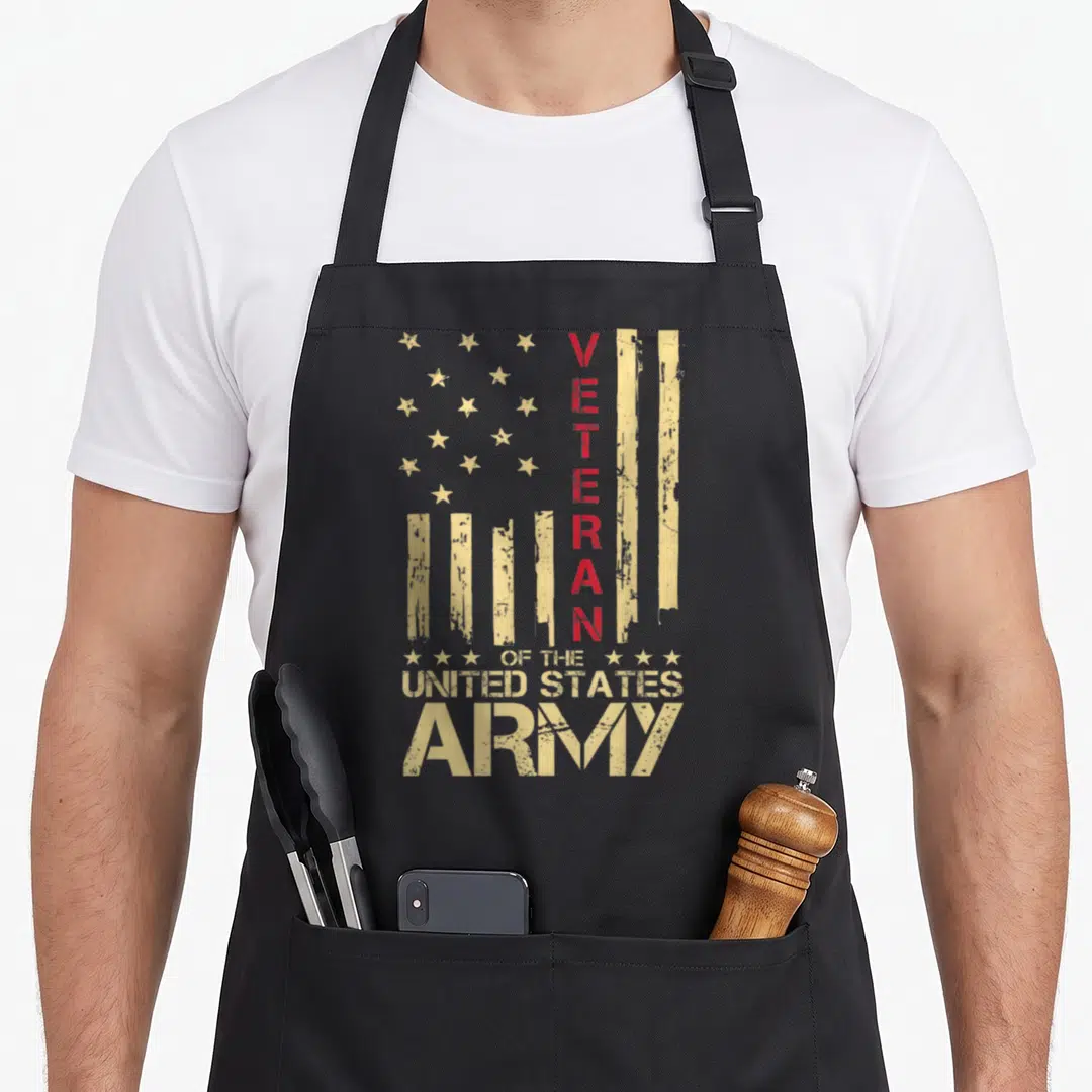 Patriotic american flag apron - Distressed tan stars and stripes with vertical red VETERAN text and stacked Army — shown on a black cotton canvas apron against a white background