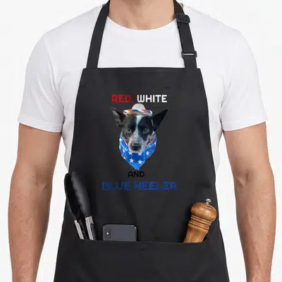 Definition dog kitchen apron - Dog photo with red white and blue heeler text and star bandana — shown on a black cotton canvas apron against a white background