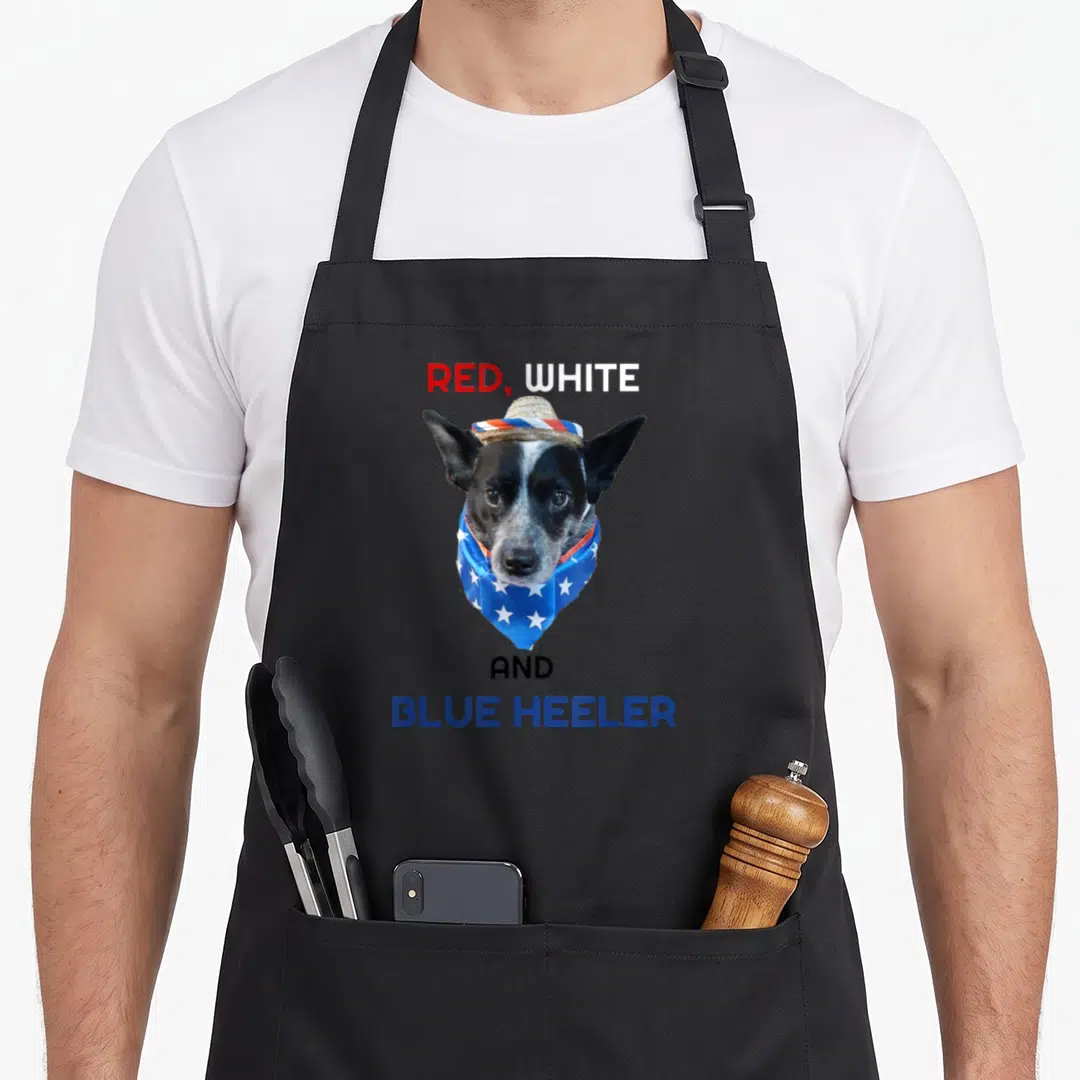 Definition dog kitchen apron - Dog photo with red white and blue heeler text and star bandana — shown on a black cotton canvas apron against a white background