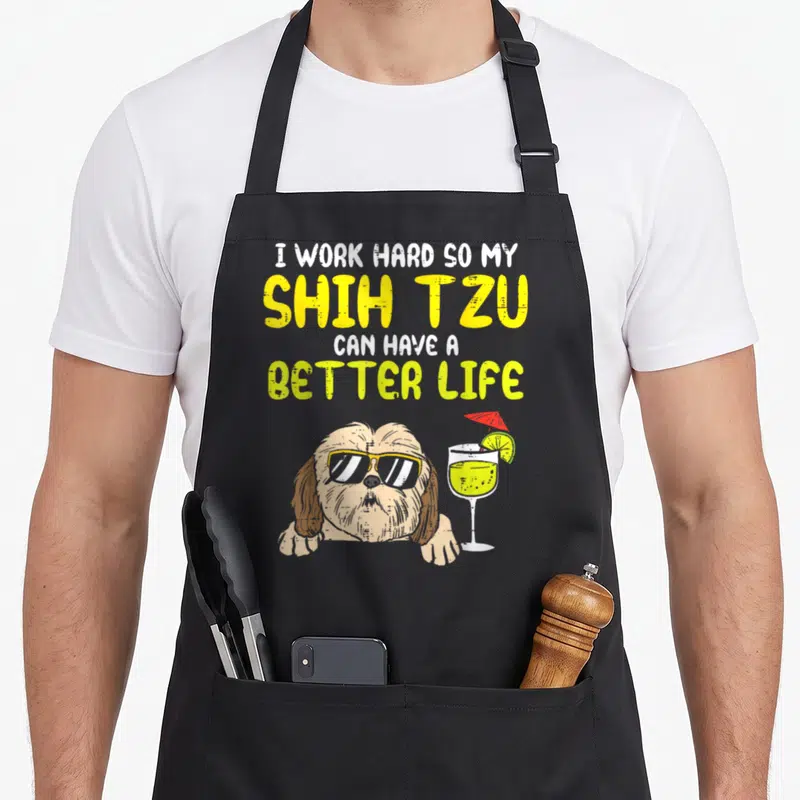 Hard shih dog apron - Cartoon shih tzu with sunglasses and cocktail below stacked text about better life — shown on a black cotton canvas apron against a white background