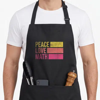 Peace teacher apron - PEACE LOVE MATH text next to yellow coral pink distressed rectangles — shown on a black cotton canvas apron against a white background