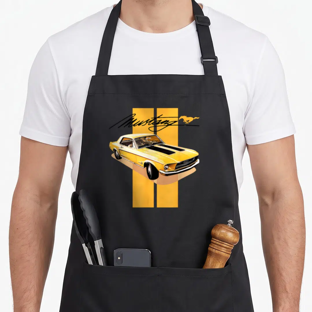 Mustang stripe apron - Yellow Ford Mustang car over two vertical stripes with script text and horse logo in black — shown on a black cotton canvas apron against a white background