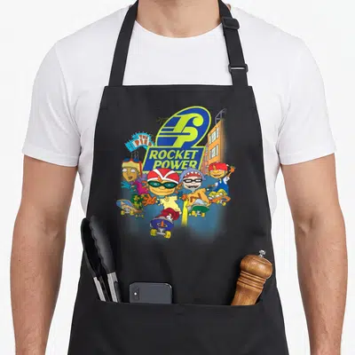 Rocket arugula apron - Four cartoon skaters with blue yellow orange and green Rocket Power logo and pier sign — shown on a black cotton canvas apron against a white background