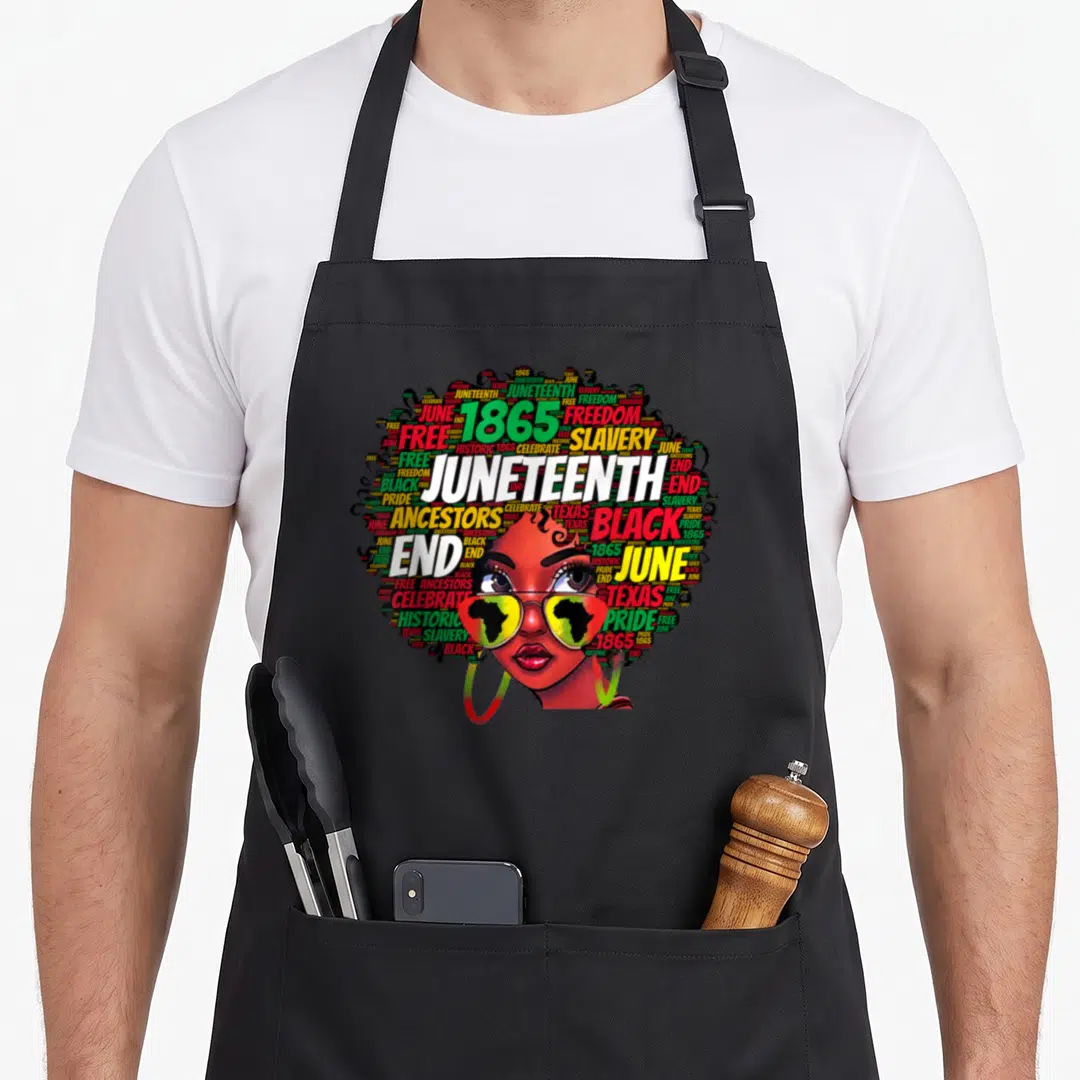 Juneteenth messy aprons - Woman with word-cloud hair saying Juneteenth 1865 freedom black pride wearing Africa map — shown on a black cotton canvas apron against a white background