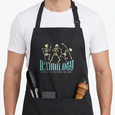 Radiology rad x ray apron - Three dancing skeletons above blue text reading Radiology and a pun about inside contents — shown on a black cotton canvas apron against a white background