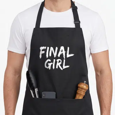 Slasher final apron - White FINAL GIRL text in two stacked lines on black background — shown on a black cotton canvas apron against a white background