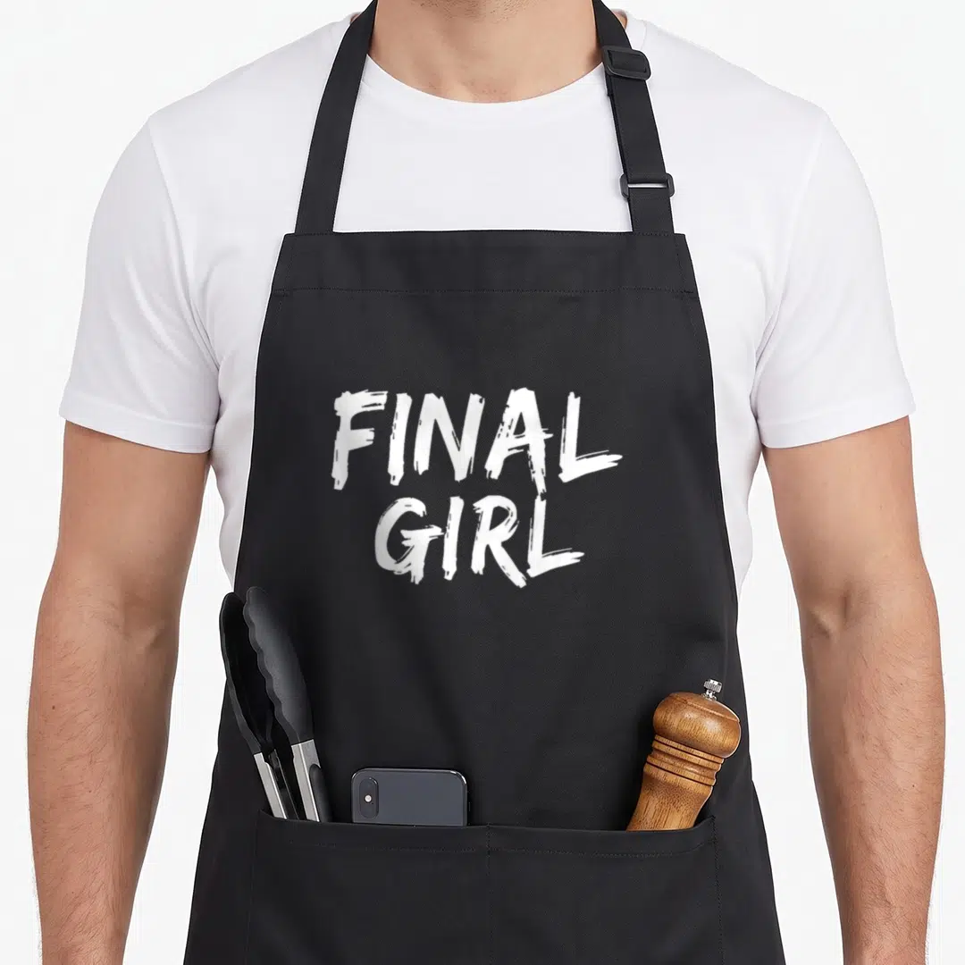 Slasher final apron - White FINAL GIRL text in two stacked lines on black background — shown on a black cotton canvas apron against a white background
