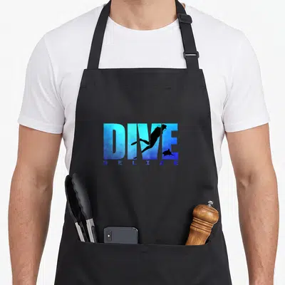 Dive belizean apron - Blue gradient DIVE text with diver shark silhouettes and spaced BELIZE letters — shown on a black cotton canvas apron against a white background