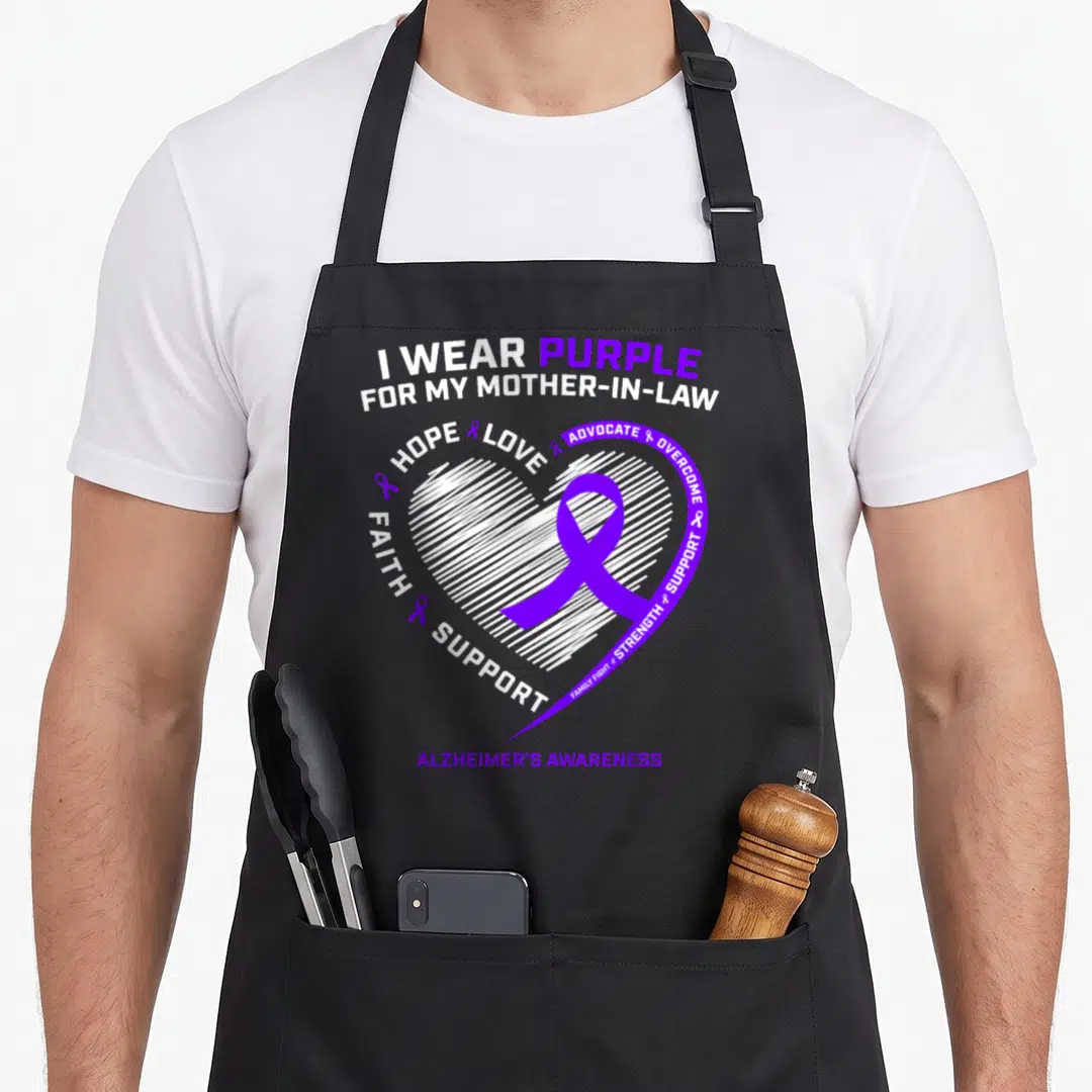 Dementia mother's apron - Purple ribbon inside white sketched heart with I WEAR PURPLE FOR MY MOTHER-IN-LAW text — shown on a black cotton canvas apron against a white background