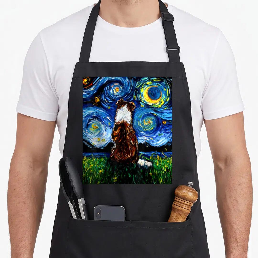 Night border collie apron - Watercolor dog facing away looking at swirling blue yellow and green night sky — shown on a black cotton canvas apron against a white background