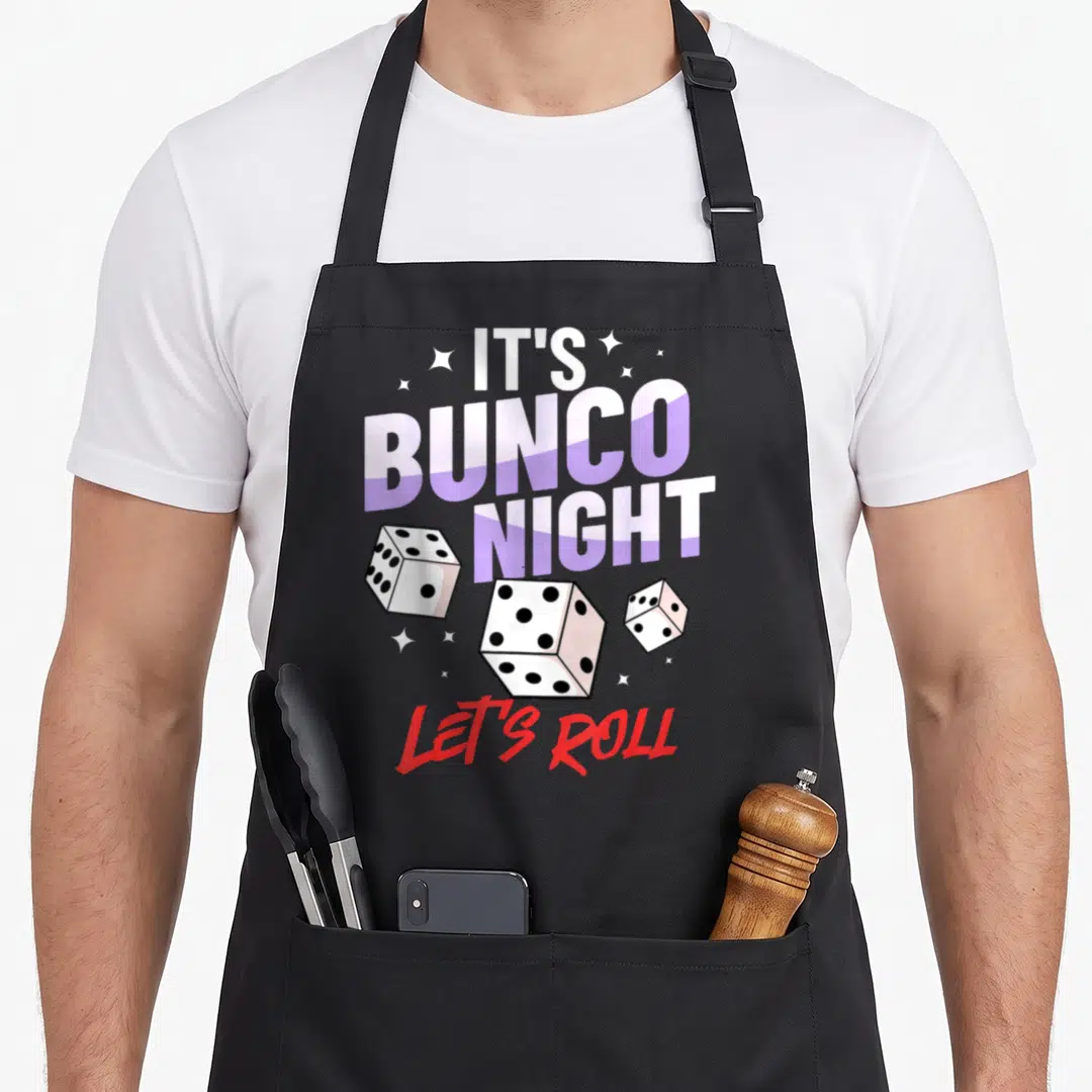 Dice game aprons - Stacked IT'S BUNCO NIGHT text with three scattered dice and Let's ROLL in red — shown on a black cotton canvas apron against a white background