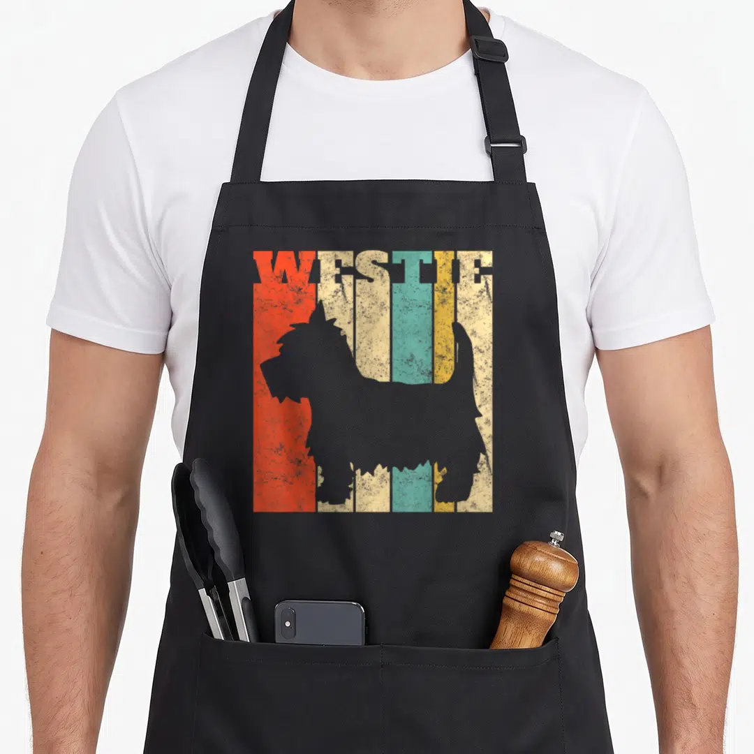 Highland westie apron - Grey dog silhouette on five vertical red beige teal yellow grey stripes withWESTIE text — shown on a black cotton canvas apron against a white background