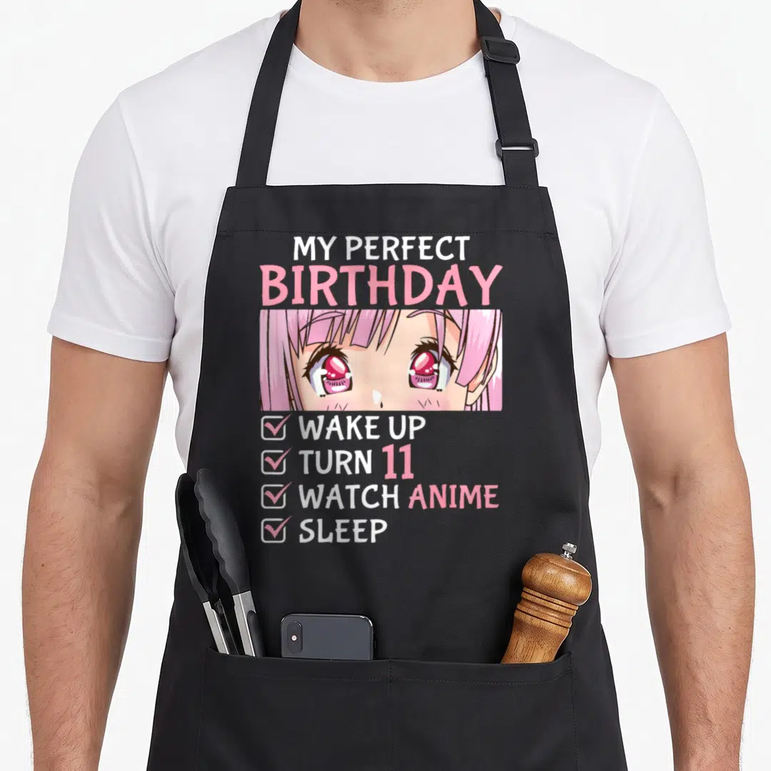 Watch anime mom apron - My Perfect Birthday text above anime girl eyes and four-item checklist in pink white red — shown on a black cotton canvas apron against a white background